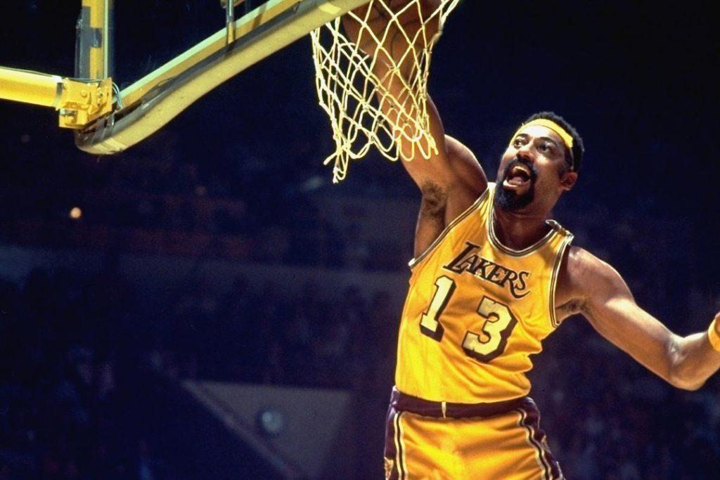 Wilt Chamberlain dunking the ball.